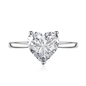 Elegant heart-shaped zircon ring with adjustable band on reflective white background