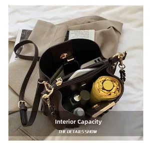 Detailed view of the dark brown bucket bag showing large internal storage capacity