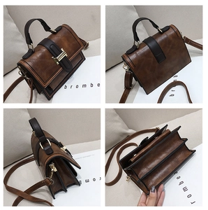 Detail view of retro brown crossbody bag with triple-compartment gusset design