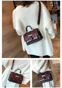 Detail showing vintage burgundy crossbody bag with retro texture and golden metal buckle