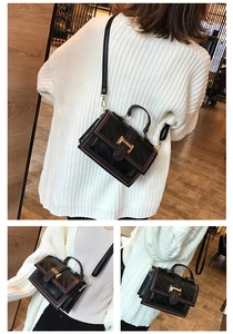 Detail view of black vintage oil wax leather crossbody bag with pink stitching and H buckle