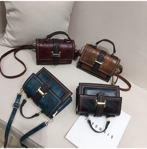 Macro detail of vintage oil wax leather bags with diamond stitching and H buckles