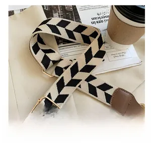 Detail of adjustable woven shoulder strap with black and white herringbone pattern