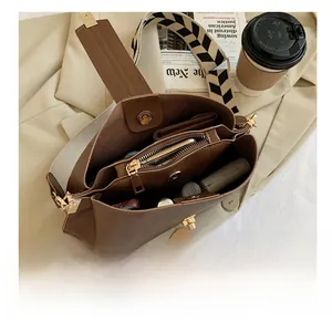 Top view of brown leather bucket bag showing interior space with zipper compartment