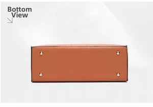 Detail view of the brown leather handbag base featuring gold protective metal feet