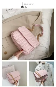 Detailed view of pink quilted shoulder bag with V-shaped stitching and gold chain strap