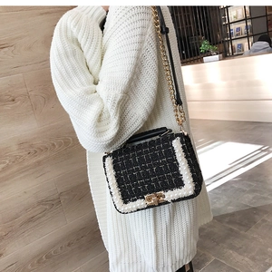 Détail du sac bandoulière en tweed avec perles et fermoir doré sur un pull en tricot blanc