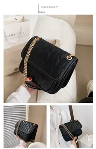 Detail of black quilted leather crossbody bag with premium gold metal chain strap