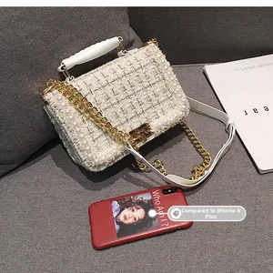 Détail du petit sac bandoulière en tweed blanc avec perles et chaîne dorée