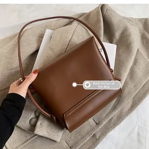 Close-up showing the sleek back design of this brown leather crossbody square bag