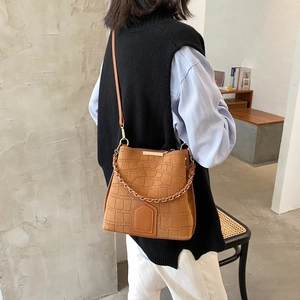 Retro brown crossbody bucket bag with embossed crocodile pattern and metal chain detail