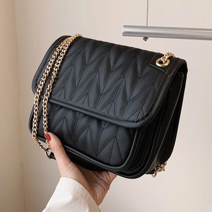 Women's black quilted chain hobo bag with V-shaped stitching and gold metal strap