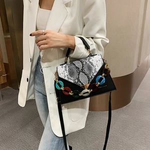 Women's black shoulder bag with snakeskin flap and colorful acrylic chain detail