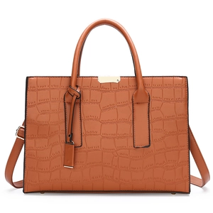 Brown crocodile textured tote bag with top handles and adjustable shoulder strap