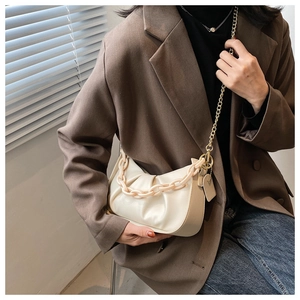 Detail of off-white cloud bag with acrylic chain strap and ruched leather texture