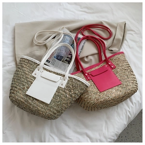 Detail of hand-woven straw tote bags with leather trim and gold rivet accents