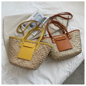 Flat lay of handmade woven straw tote bags with leather pockets in yellow and caramel