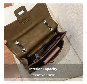 Close-up of brown chain bag interior with multiple compartments and zipper pocket