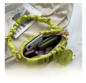 Detail view of the green pleated cloud bag interior showing ample storage space