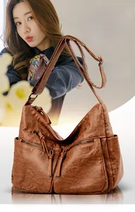 Brown vintage faux leather shoulder bag with multi-zipper pockets and fringe tassel details