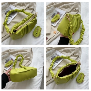Detail view of avocado green pleated cloud bag with soft PU leather and detachable strap