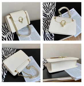 Detail view of white leather crossbody bag with golden ring lock and chain strap