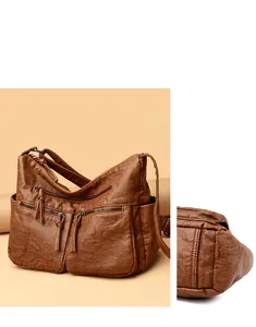 Detail view of vintage brown soft leather handbag with front zip pockets and side compartments