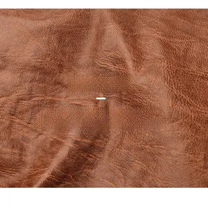 Close-up of premium dark brown lychee pattern faux leather material with rich texture