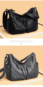 Detail of vintage soft leather shoulder bag showing multi-pocket design and texture