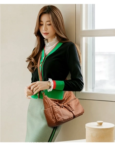 Brown vintage soft leather crossbody bag with multiple zip pockets shown on model