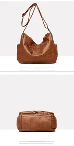 Detail view of the vintage brown faux leather bag showing rear zipper pocket and base