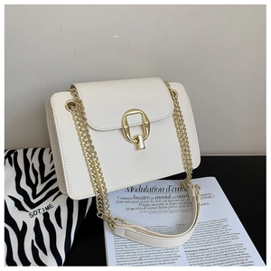 Detailed view of off-white chain bag with a gold U-shaped buckle and a chic leather strap