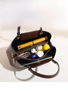 Top view of brown leather handbag interior showcasing multi-compartment storage capacity