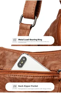 Detail of reinforced gunmetal D-ring and hidden back zipper pocket on brown leather bag