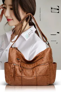 Brown soft leather tote with multiple pockets and vintage texture shown on a model