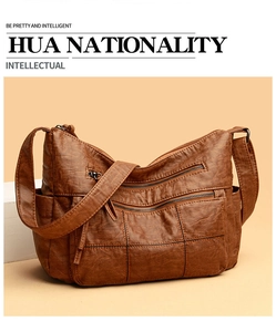 Detail of soft brown leather handbag with triple zipper pockets and vintage texture