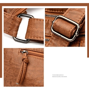 Macro detail of brown litchi pattern leather bag with adjustable matte metal buckle
