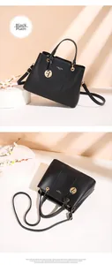 Detail view of black smooth leather tote bag with gold hardware and tassel charm