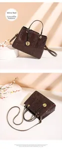 Detail view of wine red crocodile pattern handbag with golden F pendant and strap