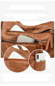 Detailed view of the multi-pocket storage design and lychee pattern on a brown shoulder bag