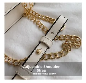 Detail of adjustable leather strap and light gold chain on cream crossbody square bag