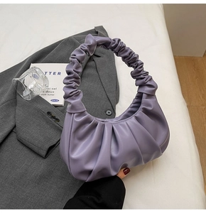 Detail of light purple pleated cloud bag with soft PU leather texture and ruched handle