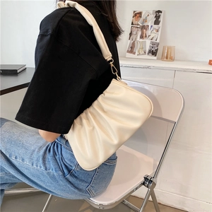 Fashionable creamy white pleated cloud bag with soft leather texture and golden metal hooks