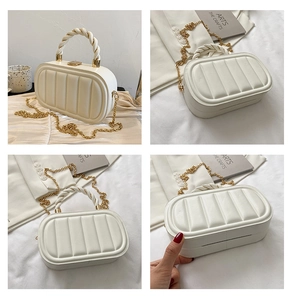 Detail of white quilted handbag with woven rope handle and golden chain shoulder strap