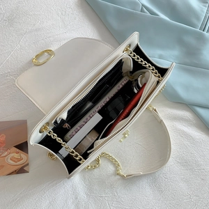 White chain shoulder bag featuring a spacious interior with multiple compartments