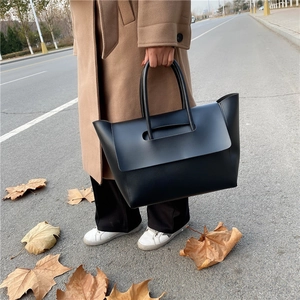 Minimalist black tote bag in matte synthetic leather for 2024 fashion commutes