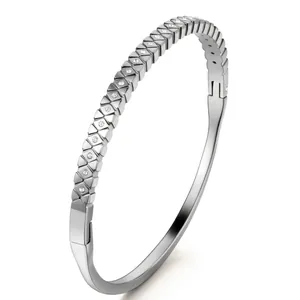 Macro shot of silver geometric faceted bangle with cubic zirconia inlay and clasp detail