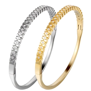 Gold and silver titanium steel bangles with star-set cubic zirconia and hinged closure