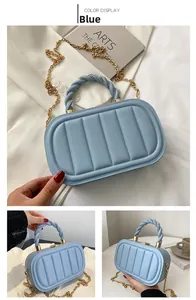 Detail of light blue quilted mini bag featuring vertical stripes and gold chain strap