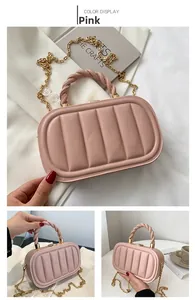 Detailed close-up of pink round mini bag with gold chain strap and textured handle
